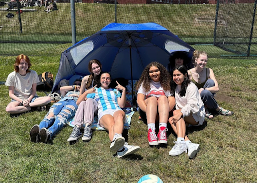Students hanging out under a tent